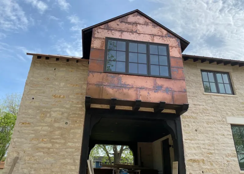 Copper metal panel facade on a stone building for Skylight Installation in Leonia